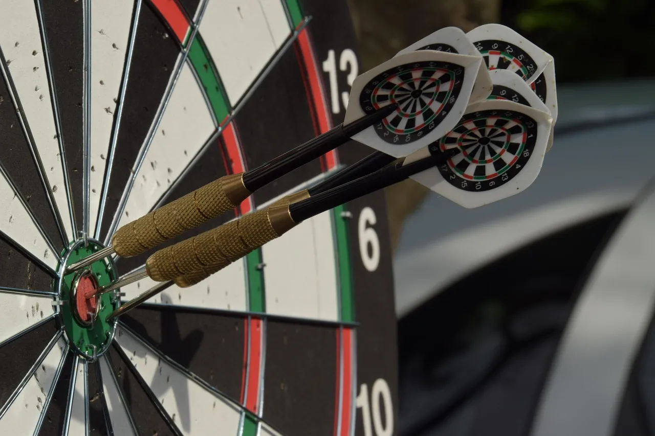 Zwei Dartpfeile stecken in einer Dartscheibe